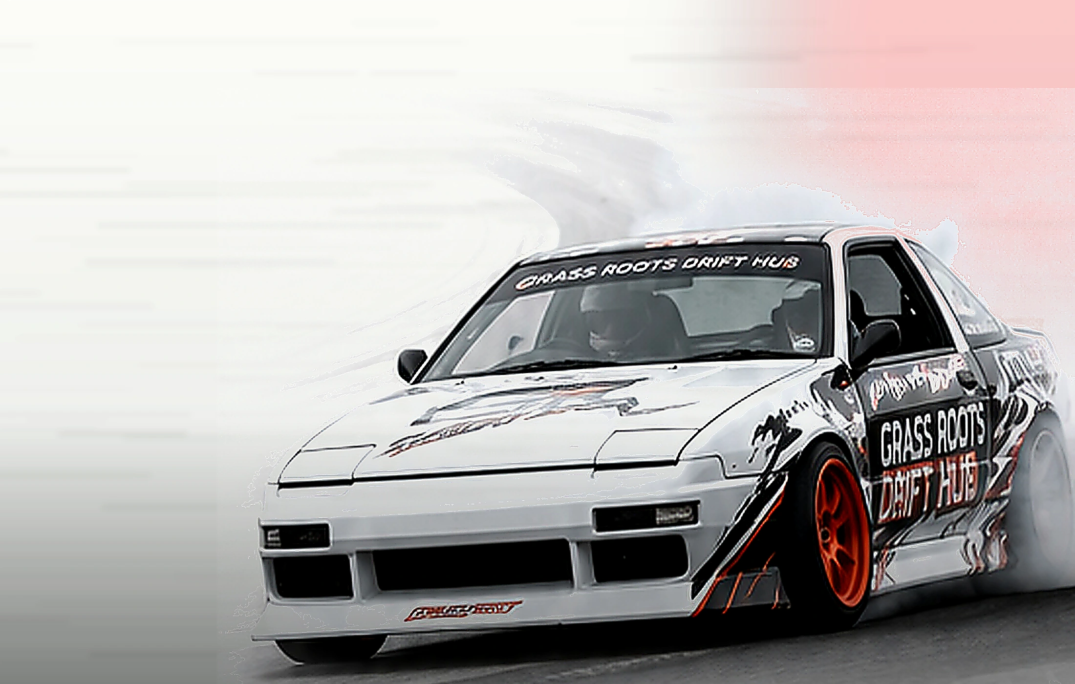 Drift car surrounded by tire smoke