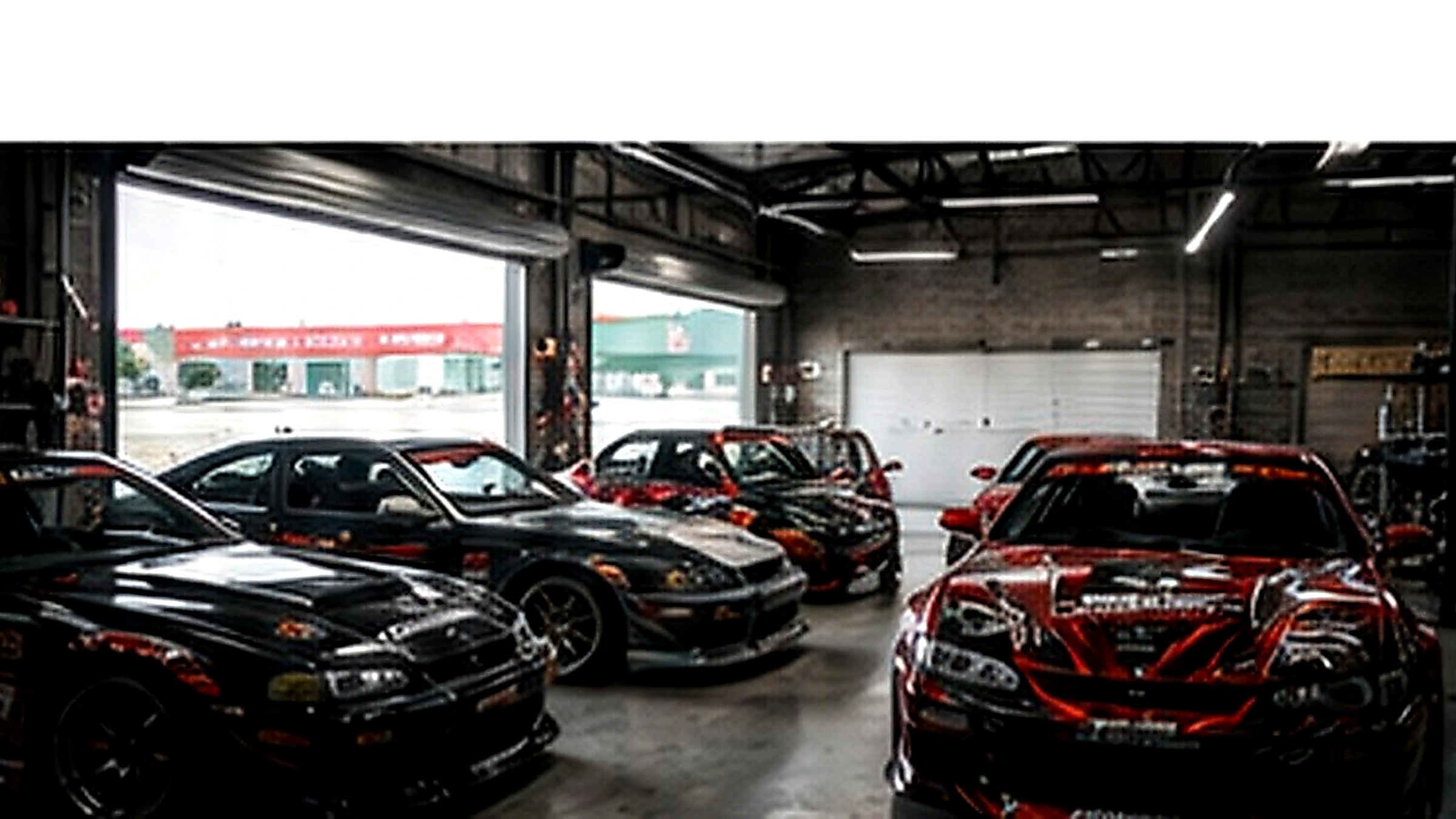 Grassroots drift cars inside a workshop