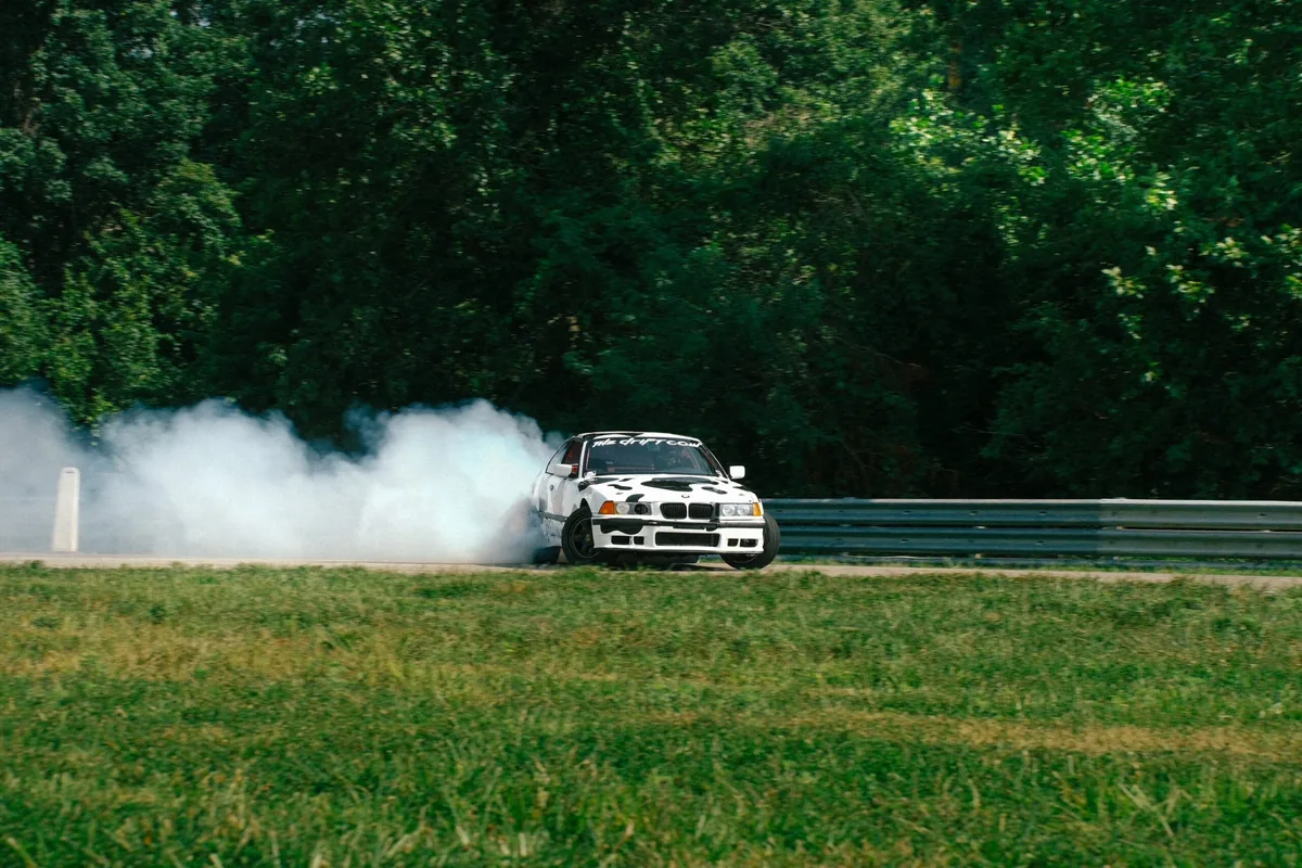Drift car laying down a full cloud of tire smoke